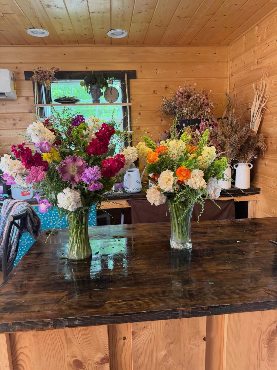 Two colorful bouquets in the Havens Hill flower workspace