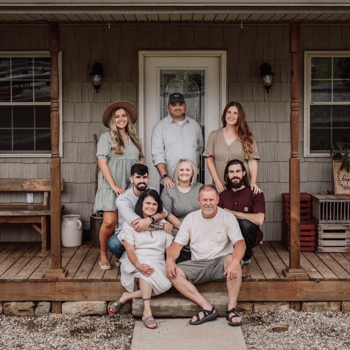A group gathered for a portrait on a farmhouse porch