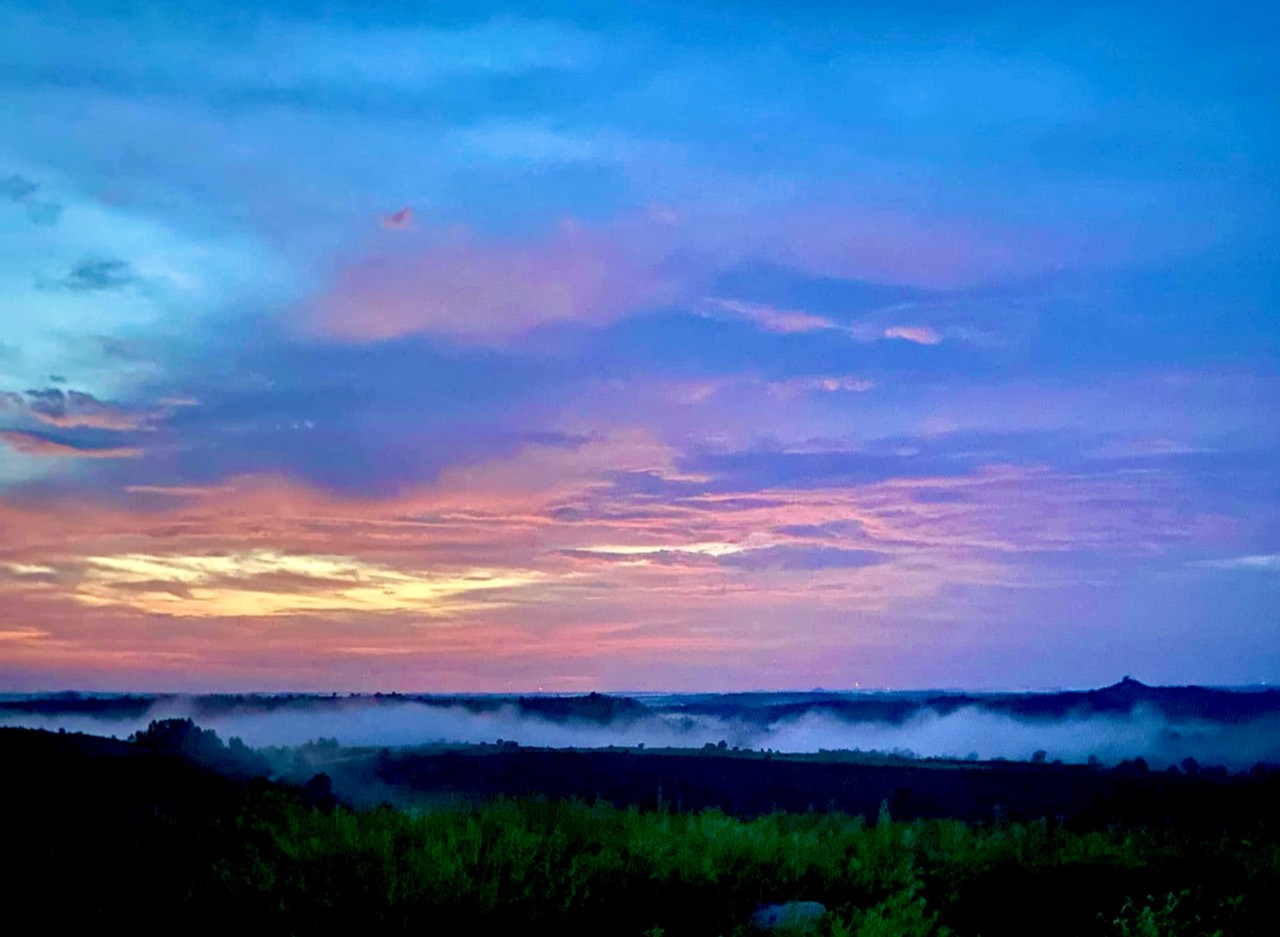 Morning mist drifting through layered Kentucky hills